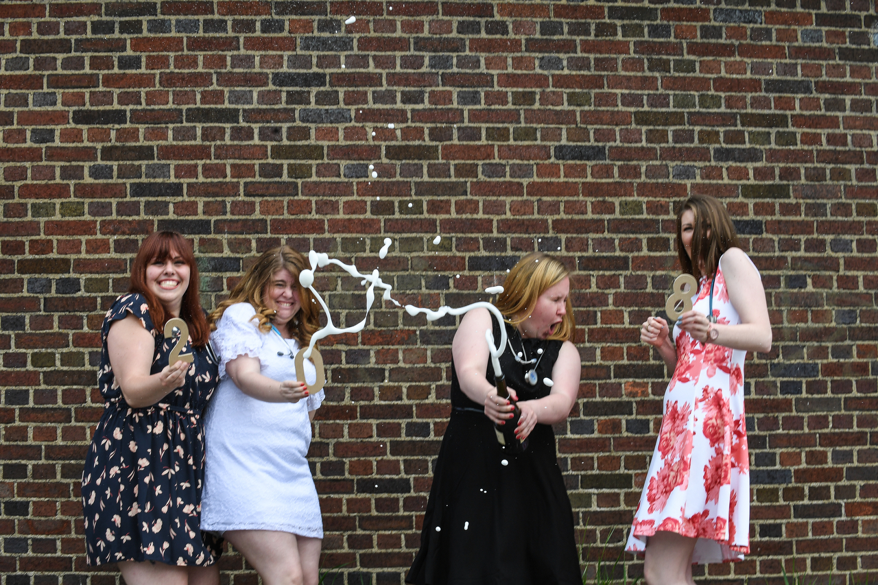 College graduates popping the cork